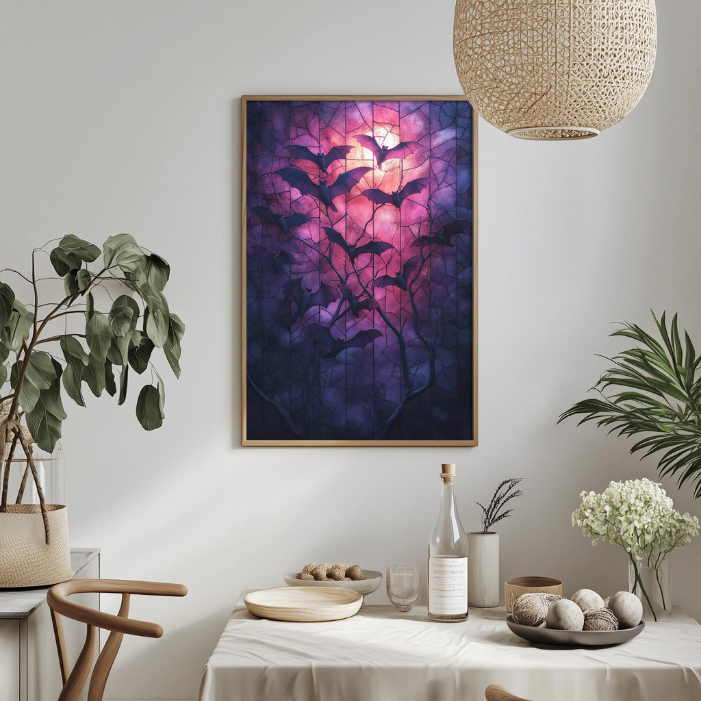 a dining table with a white tablecloth, a bowl of fruit, a bottle, and a vase with flowers. Above the table, there is a framed painting of bats against a purple and pink background.