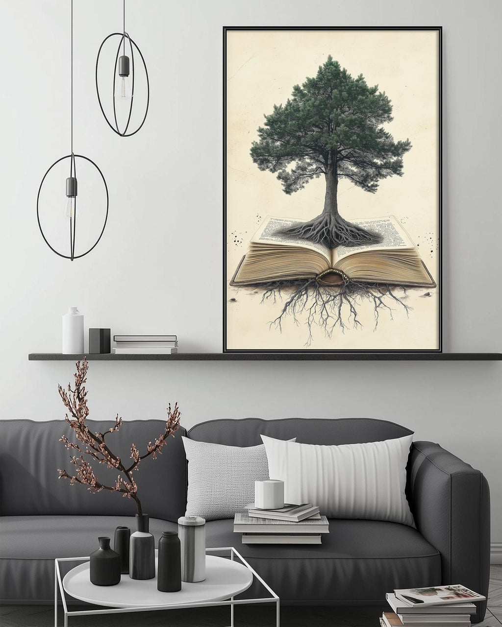 a large framed artwork depicting a tree with roots emerging from an open book, set against a white wall. The artwork is displayed above a gray couch with a coffee table in front of it. The room has a minimalist and modern design, with a pendant light fixture hanging above the artwork and a shelf with various decorative items.