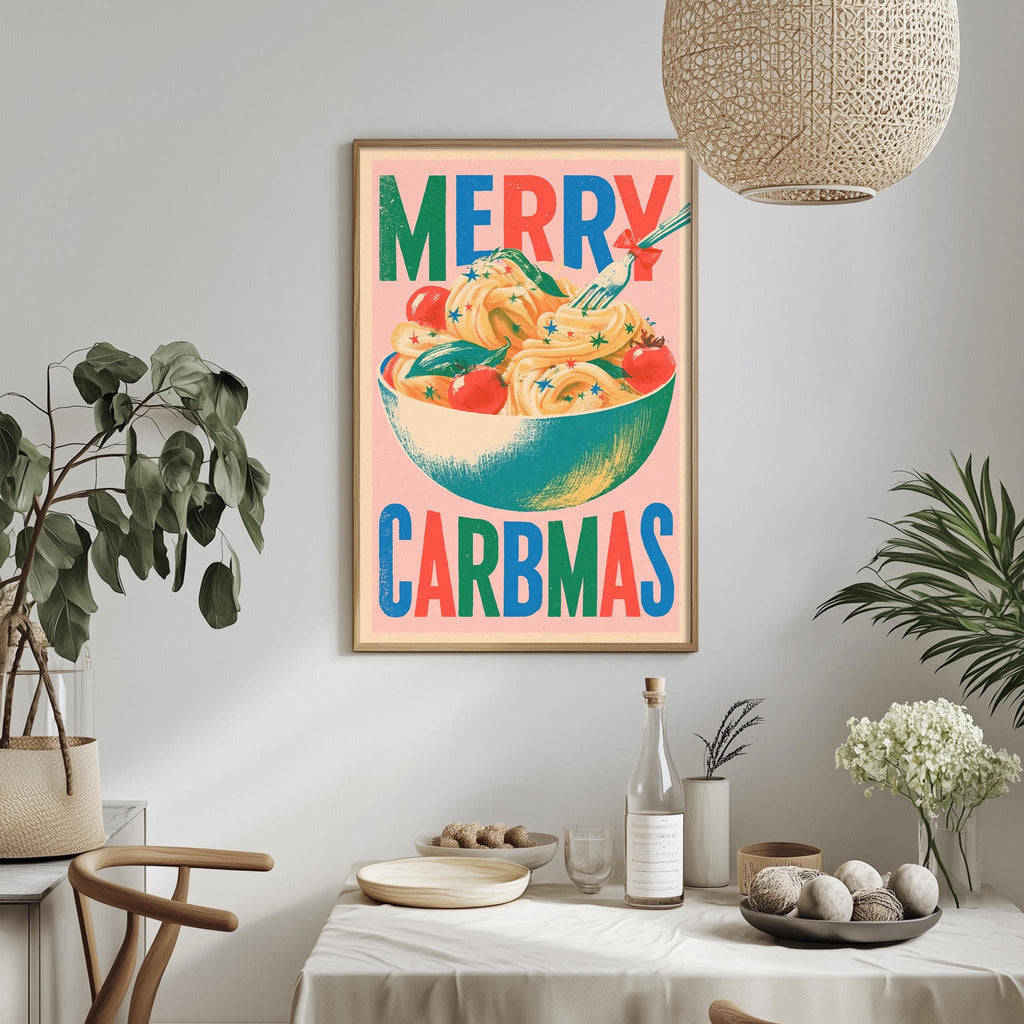 a framed poster with the text "MERRY CARBMAS" hanging on a wall above a dining table with various items on it.