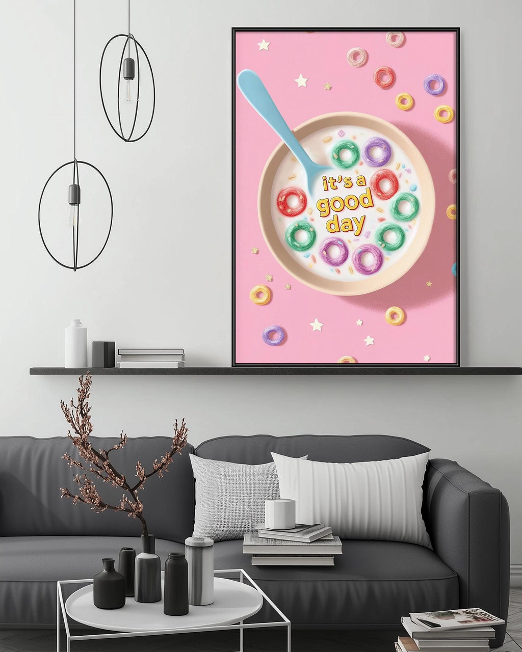 a cozy living room with a gray couch, a coffee table, and a framed poster of a bowl of cereal with a spoon and the text "It's a good day" on it.