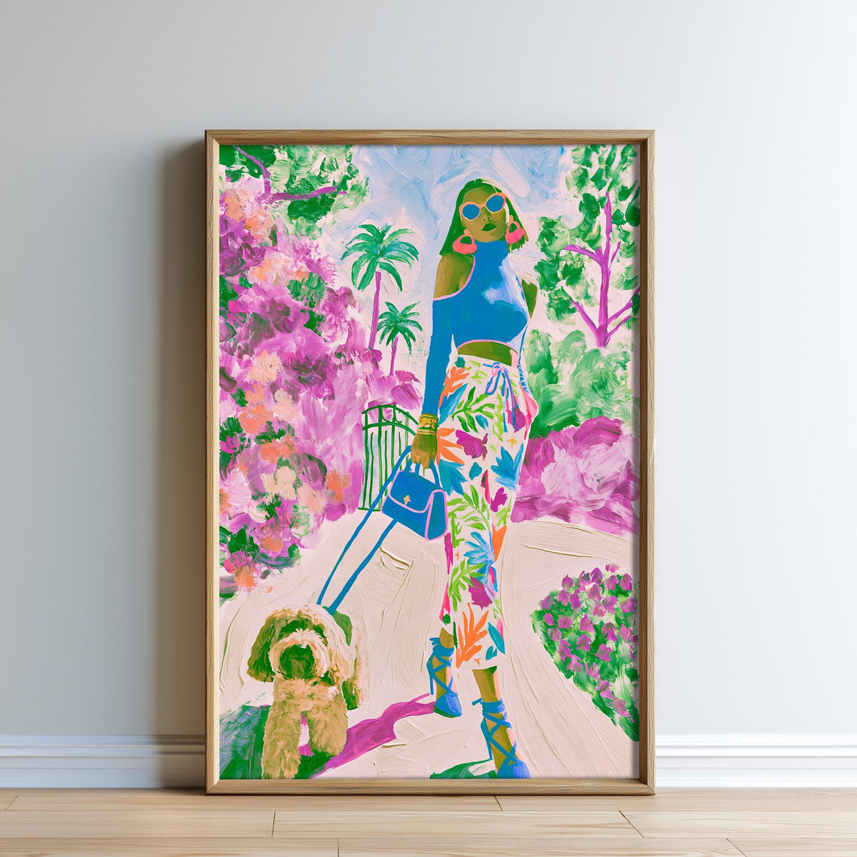 A colorful painting of a woman in a tropical setting, with a dog in the foreground, is displayed on a wall.