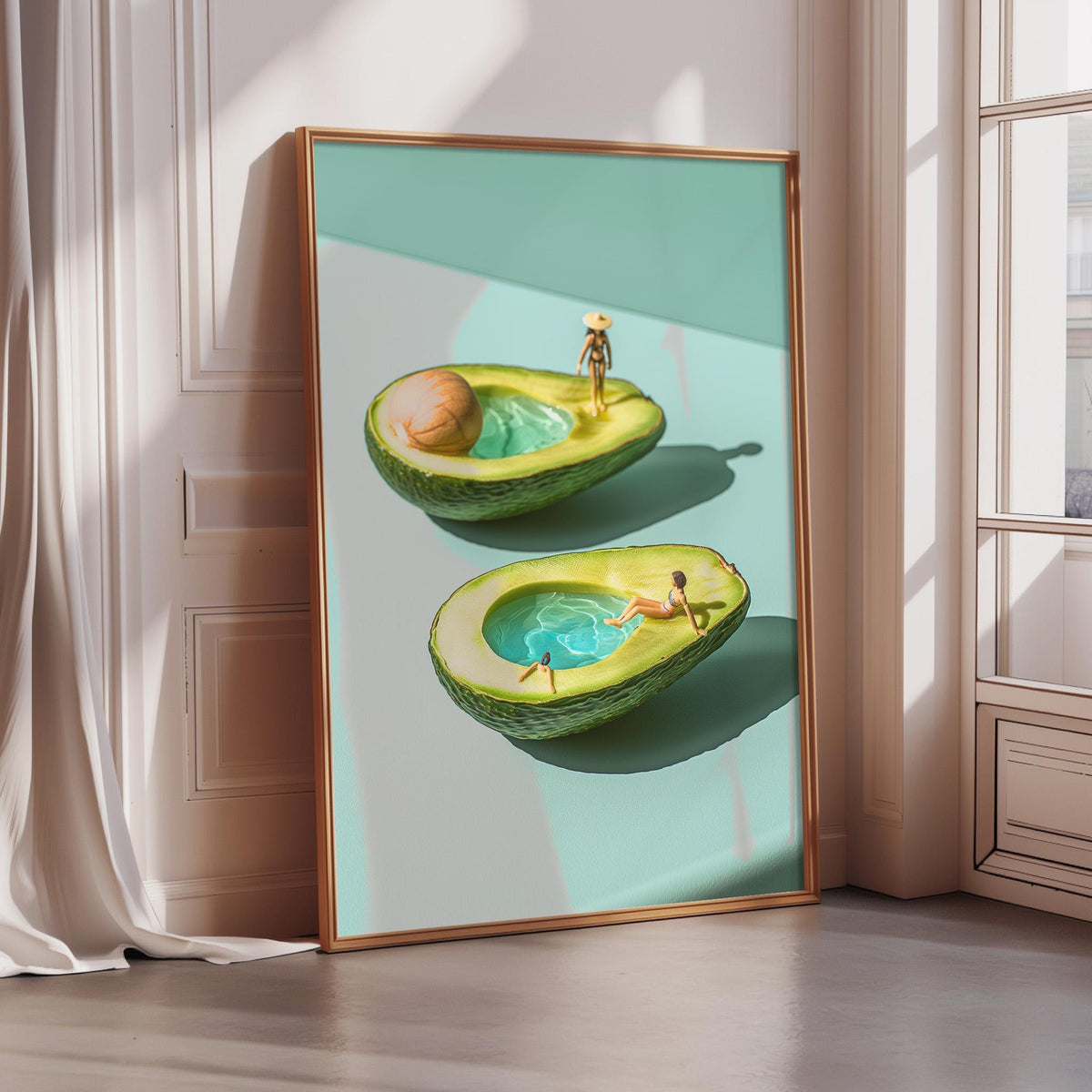 The image is a framed artwork depicting two avocados with miniature figures inside them, creating a whimsical and surreal scene.