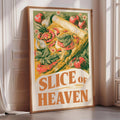 a framed poster with a vibrant illustration of a slice of pizza surrounded by various vegetables, including tomatoes, basil, and other herbs. The poster has the text "SLICE OF HEAVEN" prominently displayed.