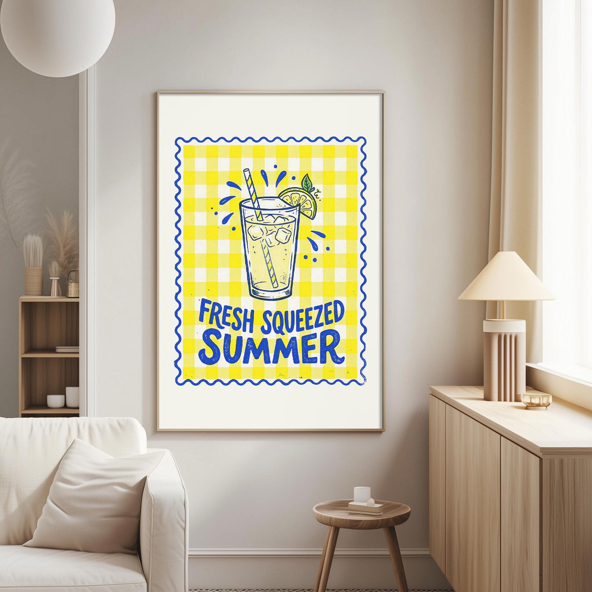 a living room with a white couch, a wooden side table, and a framed poster on the wall that says "FRESH SWEEZED SUMMER".