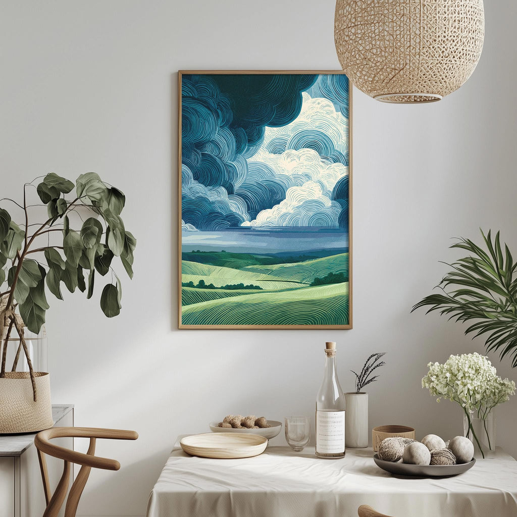 a dining table with a white tablecloth, a vase of white flowers, a bottle of wine, and a bowl of fruit. Above the table, there is a framed painting of a landscape with a cloudy sky.