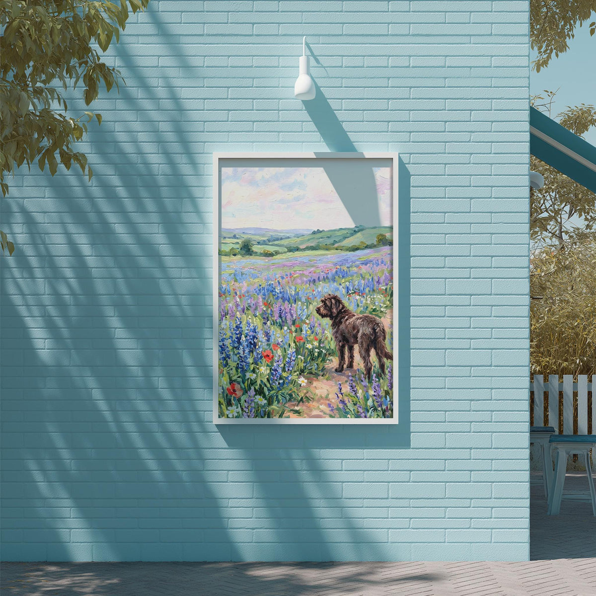 A framed painting of a dog standing in a field of colorful flowers is displayed on a blue brick wall.