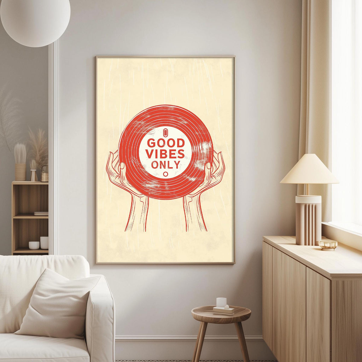 a poster with a red vinyl record and the text "GOOD VIBES ONLY" displayed on a wall in a living room setting.