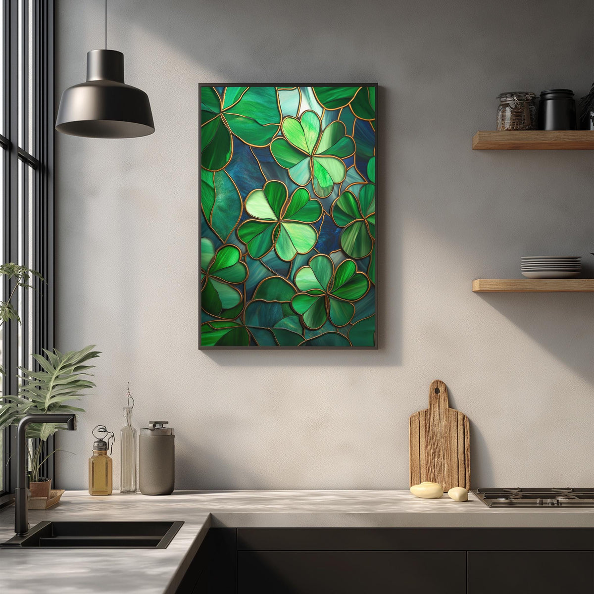 a kitchen counter with a framed stained glass artwork of green shamrocks hanging on the wall above it. The counter also has various kitchen items such as a cutting board, a soap dispenser, and a bottle.