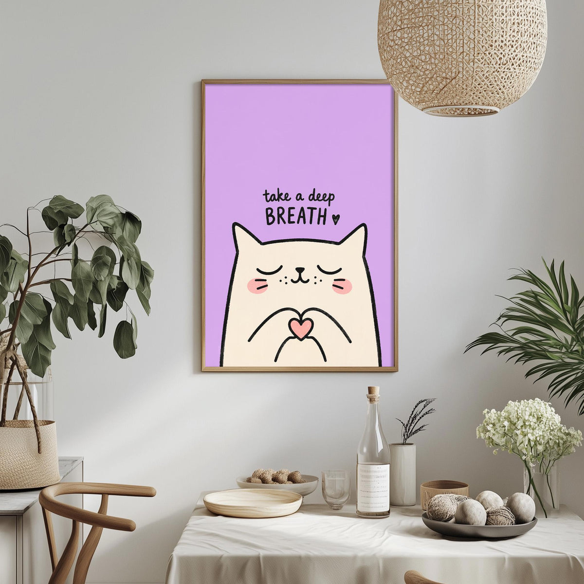 a framed poster with a cartoon cat and the text "Take a deep breath" on a purple background, hanging on a wall above a dining table with various items on it.