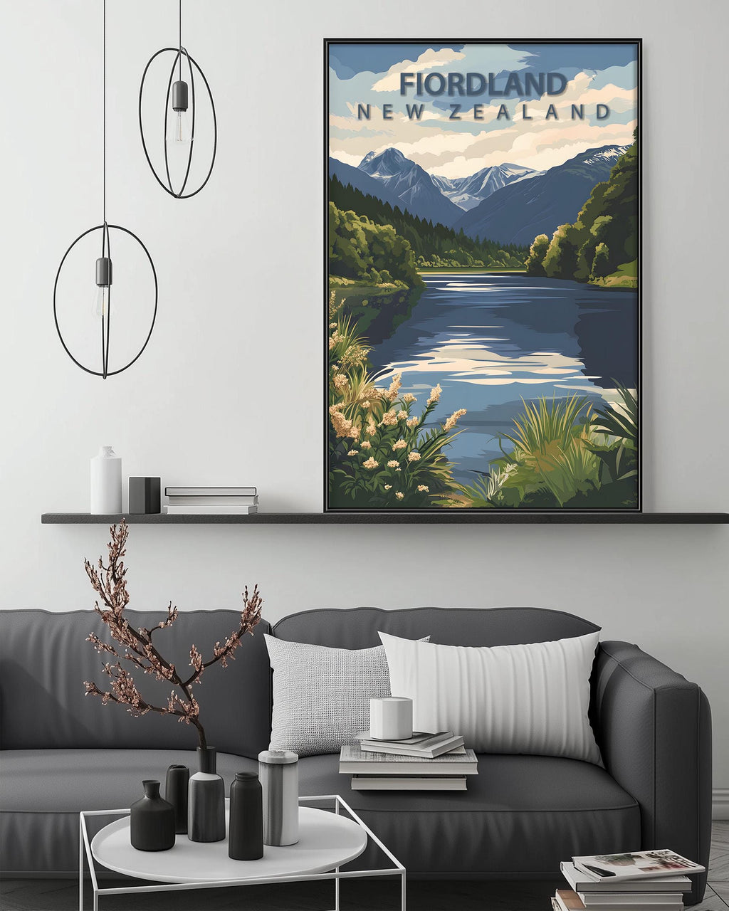a cozy living room with a gray sofa, a coffee table, and a large framed poster of a scenic landscape with mountains and a lake. The poster is titled "Fiordland New Zealand" and is hanging on the wall above the sofa.