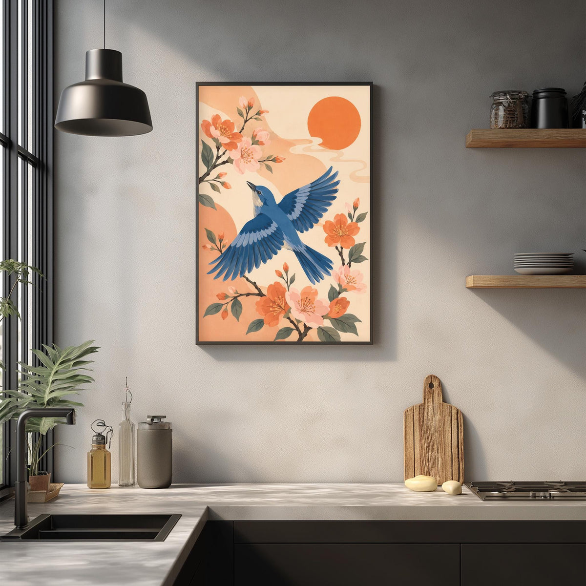 a framed illustration of a blue bird in flight, surrounded by orange flowers and a large orange sun in the background, hanging on a wall above a kitchen counter.