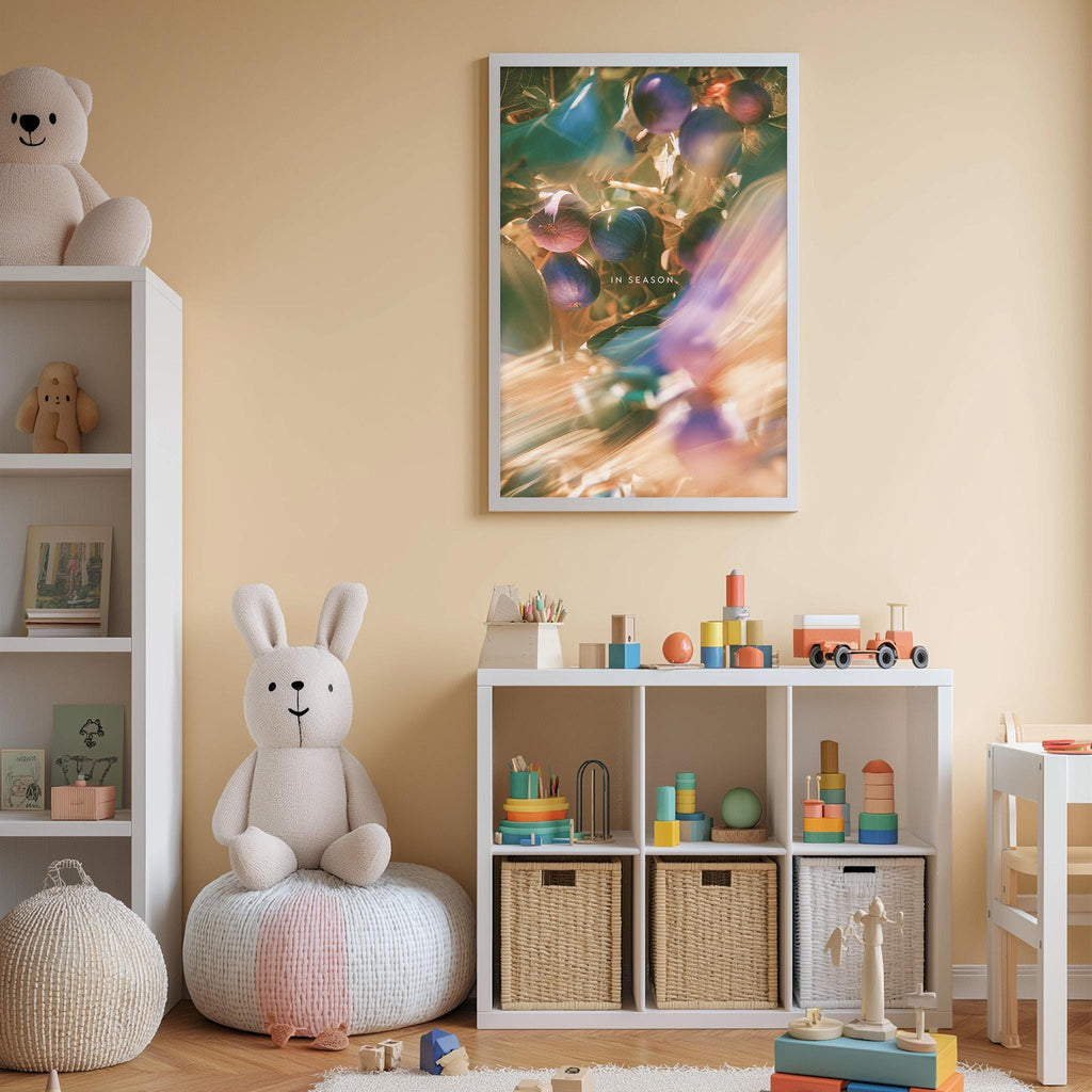 A cozy and colorful children's bedroom with a white bookshelf, a plush rabbit, and a toy train set. The walls are painted a light peach color, and there is a framed picture hanging above the bookshelf.