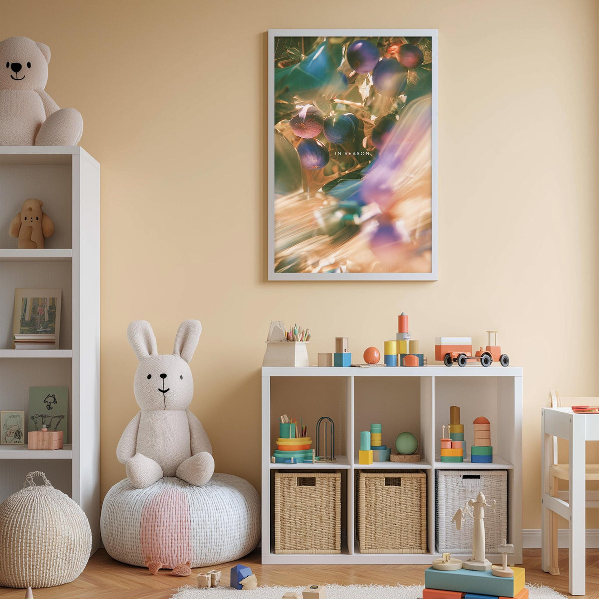 A cozy and colorful children's bedroom with a white bookshelf, a plush rabbit, and a toy train set. The walls are painted a light peach color, and there is a framed picture hanging above the bookshelf.