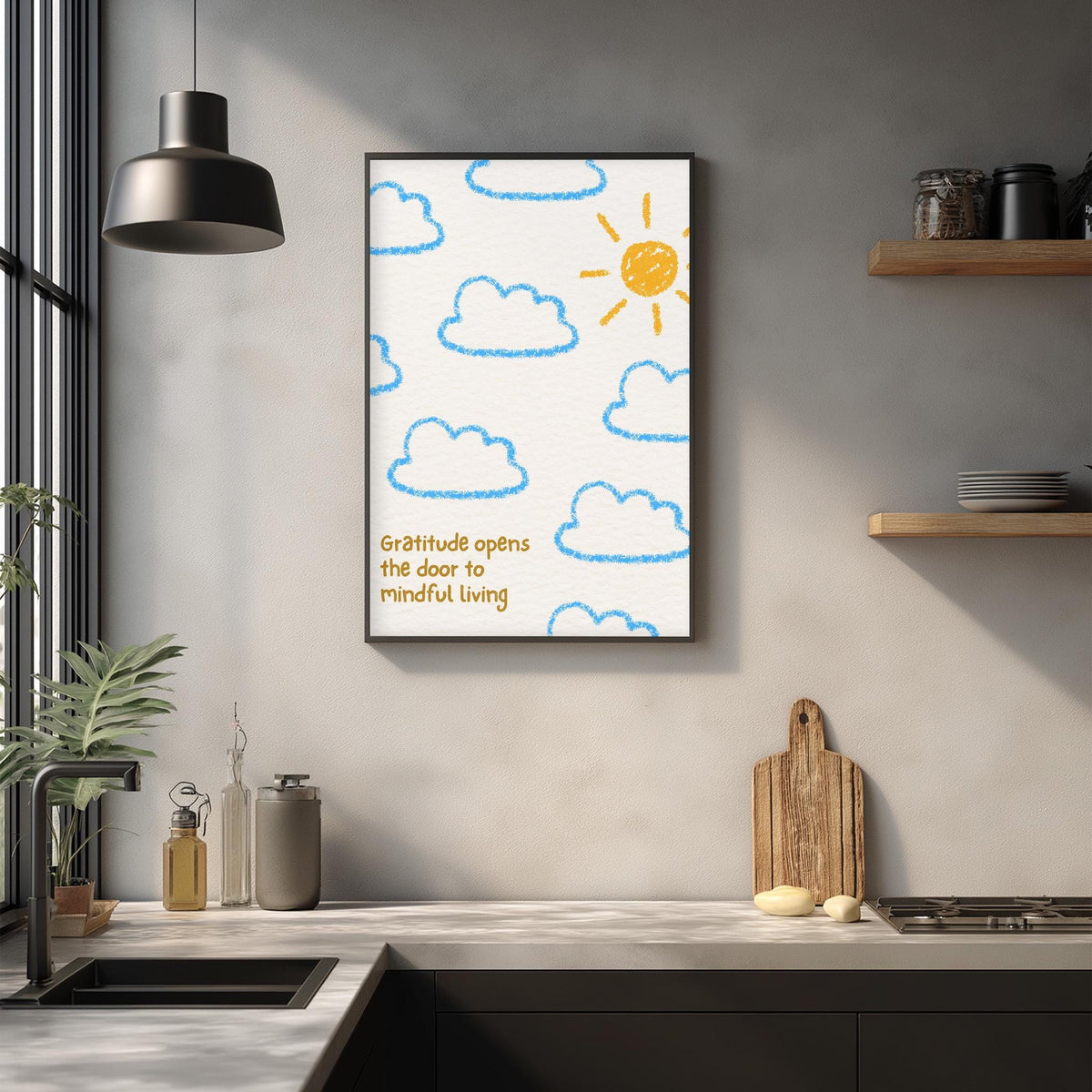 a kitchen counter with various kitchen items, such as a cutting board, a soap dispenser, and a bottle. Above the counter, there is a framed poster with a drawing of a sun and clouds, along with the text "Gratitude opens the door to mindful living".