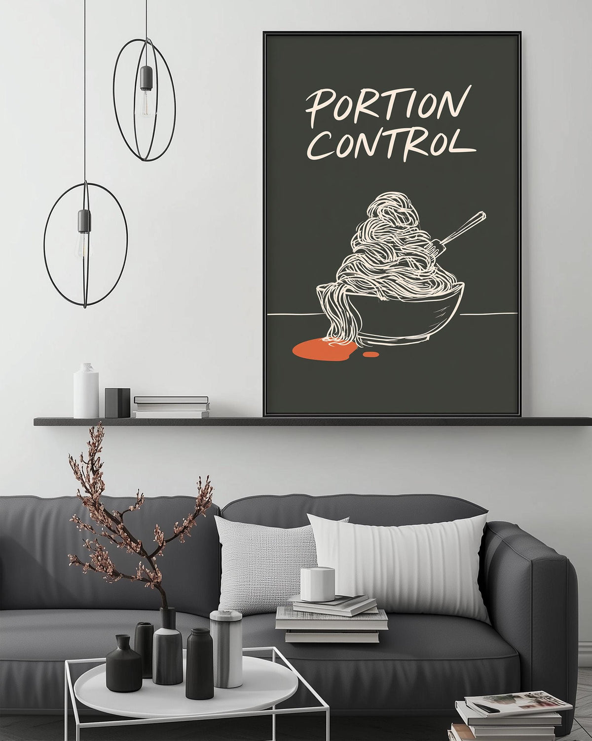 a modern living room with a gray sofa, a coffee table, and a large framed poster on the wall that says "Portion Control".