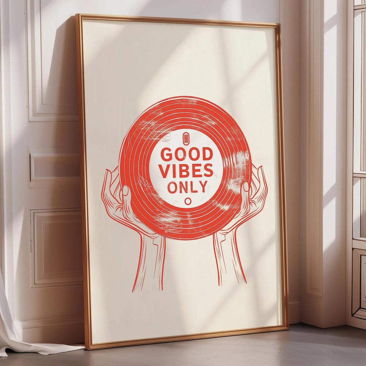 A framed poster with a red vinyl record design and the text "GOOD VIBES ONLY" is displayed on a wall.