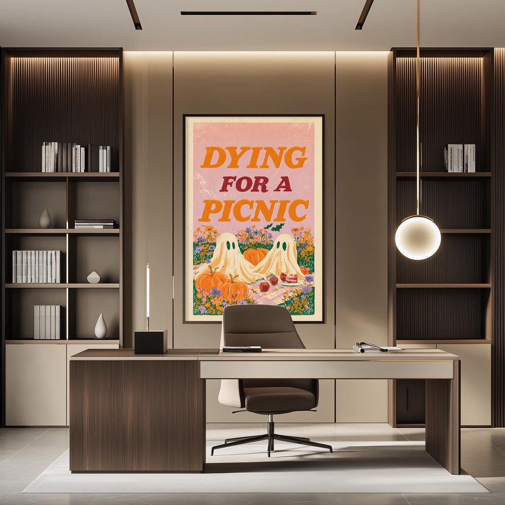 a modern office space with a desk, chair, and bookshelves. A large framed poster with the text " Dying for a Picnic" is displayed on the wall above the desk.