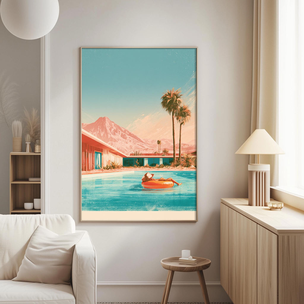 a large framed painting of a person swimming in a pool, with palm trees and mountains in the background.
