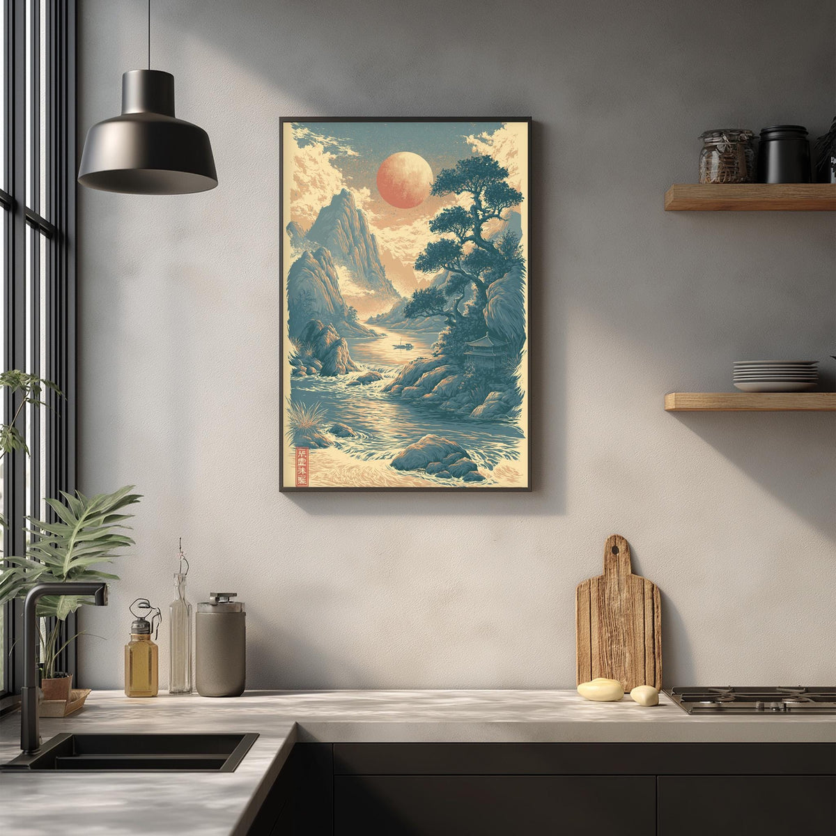 a kitchen counter with a framed landscape painting hanging above it, depicting a serene mountain scene with a large moon in the sky. The kitchen counter also has various items such as a cutting board, a bottle, and a vase.