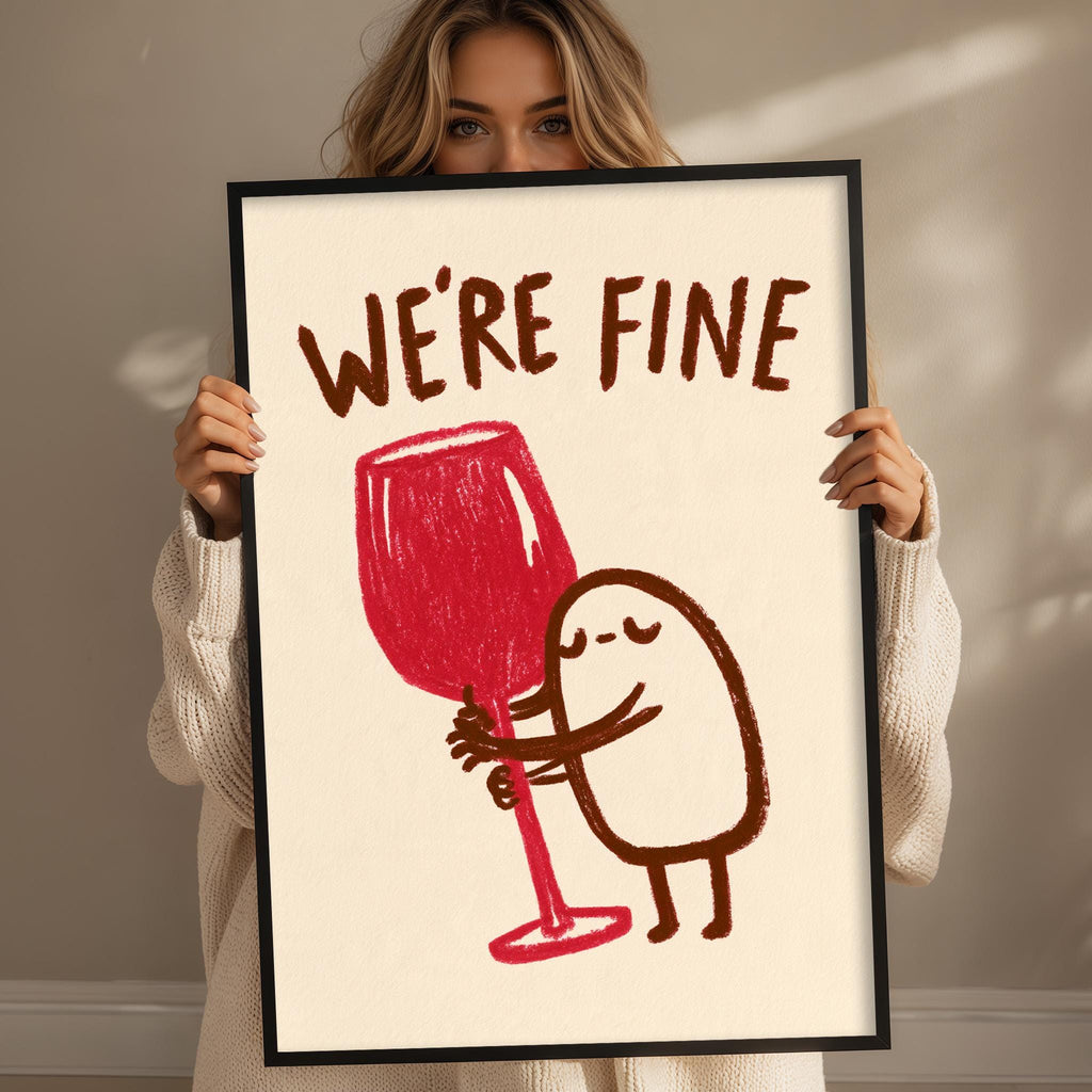 A woman is holding up a framed poster with a cartoon character and text.
