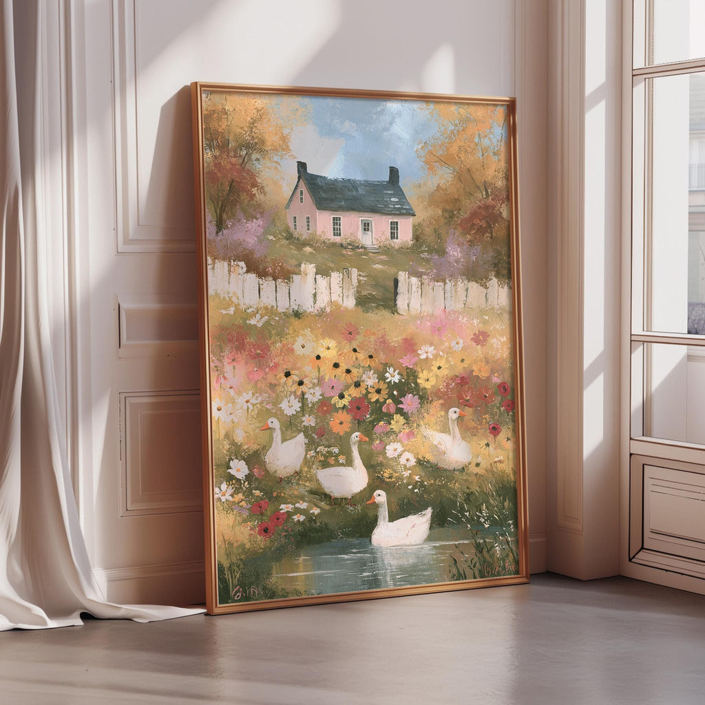 A framed painting depicting a serene garden scene with a pink house, white geese, and a pond surrounded by colorful flowers.