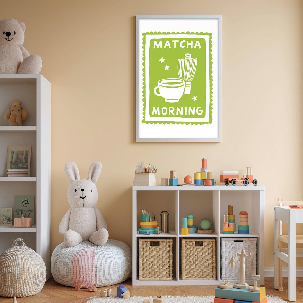 A cozy children's room with a teddy bear, a shelf with toys, and a framed poster on the wall that says "MATCHA MORNING".