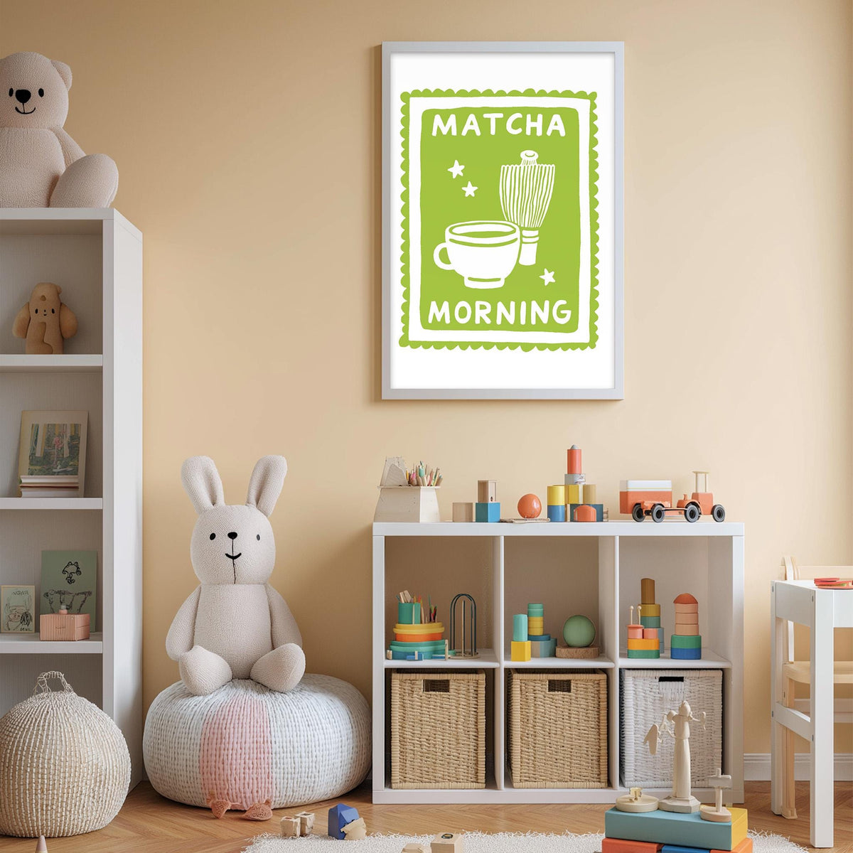 A cozy children's room with a teddy bear, a shelf with toys, and a framed poster on the wall that says "MATCHA MORNING".
