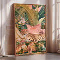 A large framed painting depicting a leopard resting on a bed of tropical foliage, with a pink pillow and a window in the background.