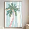 a living room with a large framed picture of a palm tree hanging on the wall. The room has a white sofa, a wooden side table, and a lamp on a nearby table.