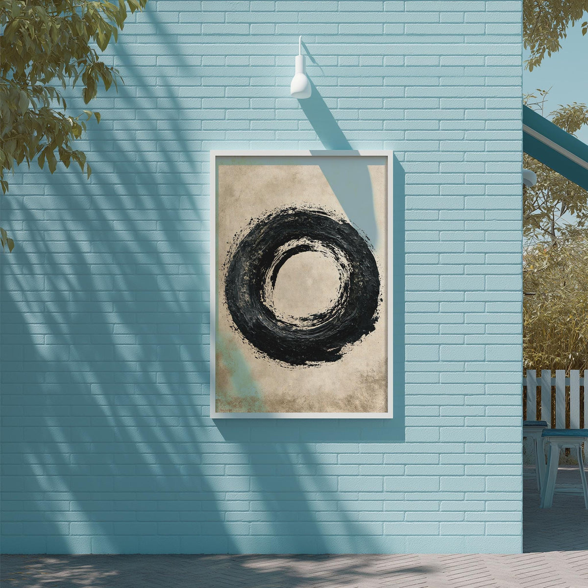 a blue wall with a framed artwork of a black circular design hanging on it.