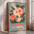 A framed poster with a floral design and a cup of coffee, along with the text "GOOD MOOD LOADING"