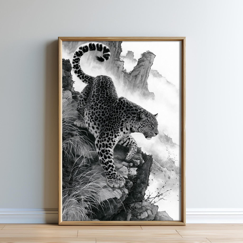 A leopard is captured in a striking black and white photograph, poised on a rocky cliff with its tail curled upwards.