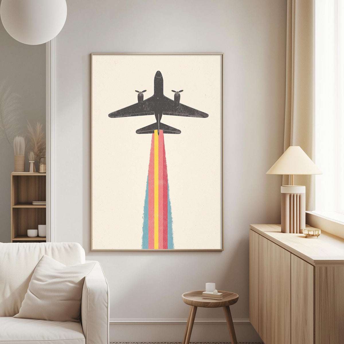 a large framed artwork depicting a plane with a colorful trail behind it, hanging on a wall in a living room setting.