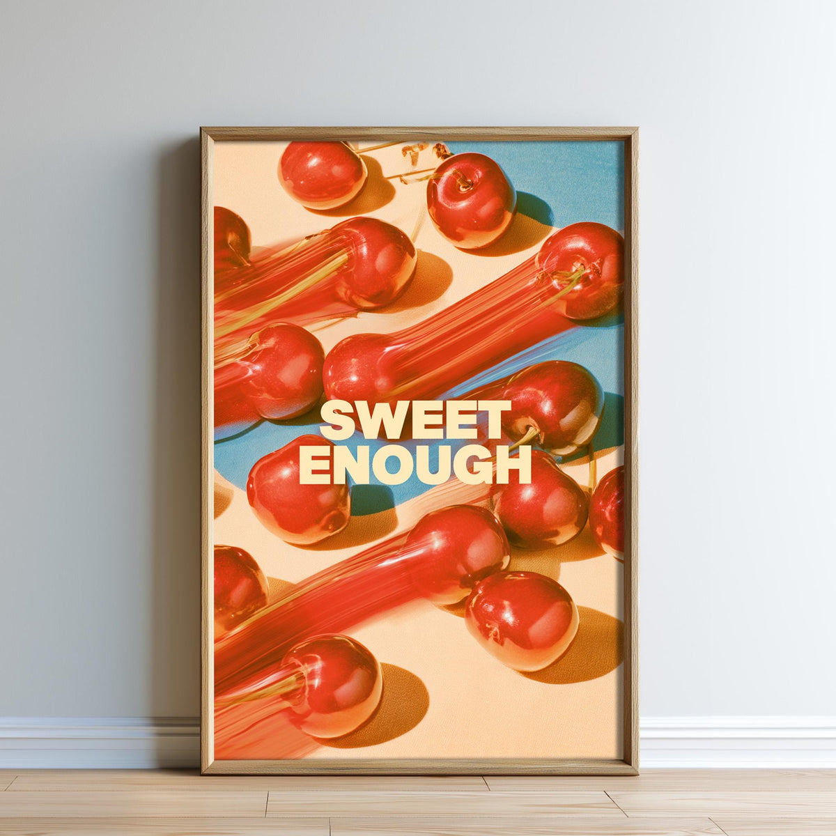 The image is a framed poster with a vibrant display of red apples arranged in a visually appealing manner. The phrase "SWEET ENOUGH" is prominently displayed in the center of the poster, creating a striking contrast against the colorful background.