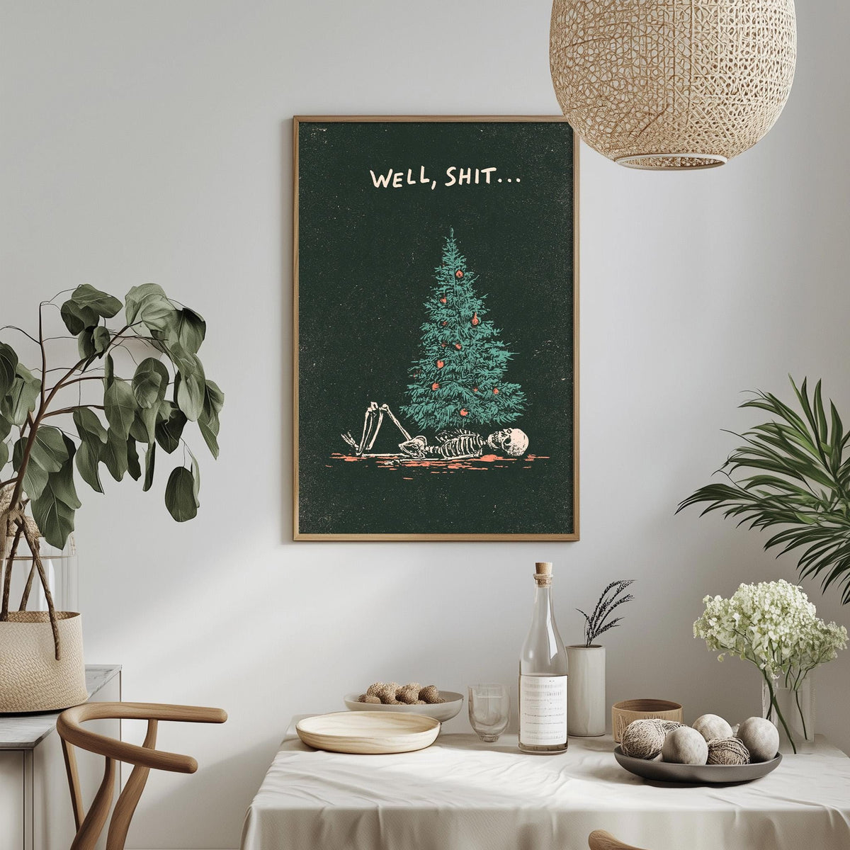 a dark green poster with a skeleton lying on a Christmas tree, accompanied by the text "WELL, SHIT..."