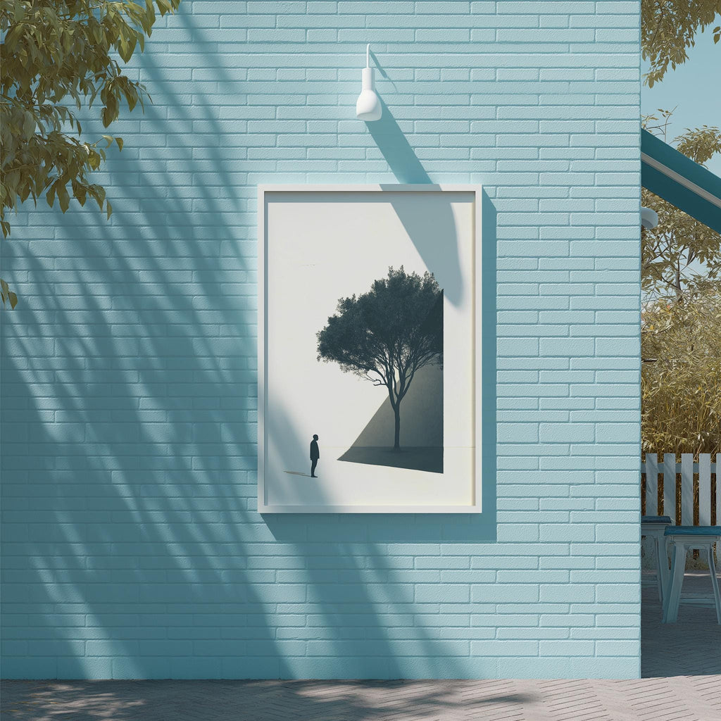 a blue brick wall with a framed picture of a tree hanging on it. The picture is slightly tilted to the left, and the tree appears to be in silhouette. The wall is situated next to a wooden deck with a bench, and there are trees visible in the background.