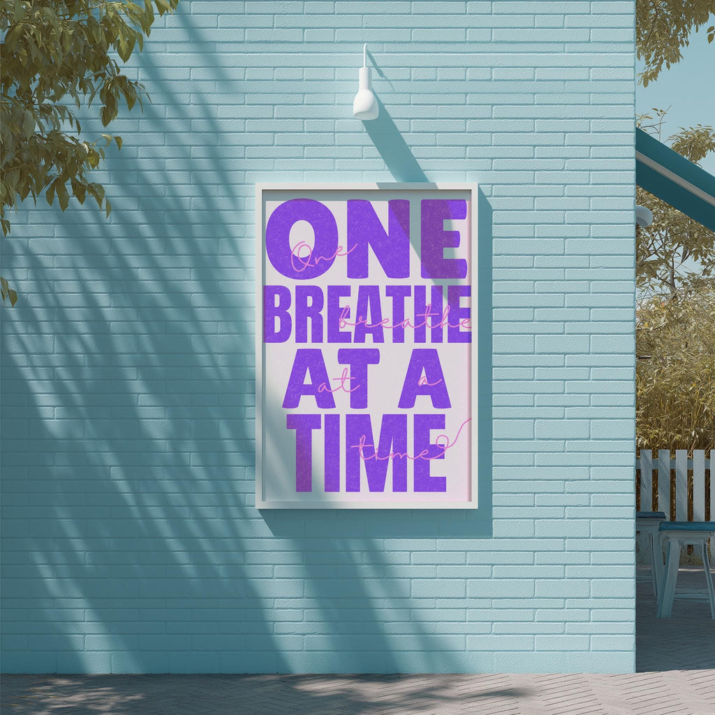 a large poster with the text "ONE BREATHE AT A TIME" displayed on a blue brick wall.
