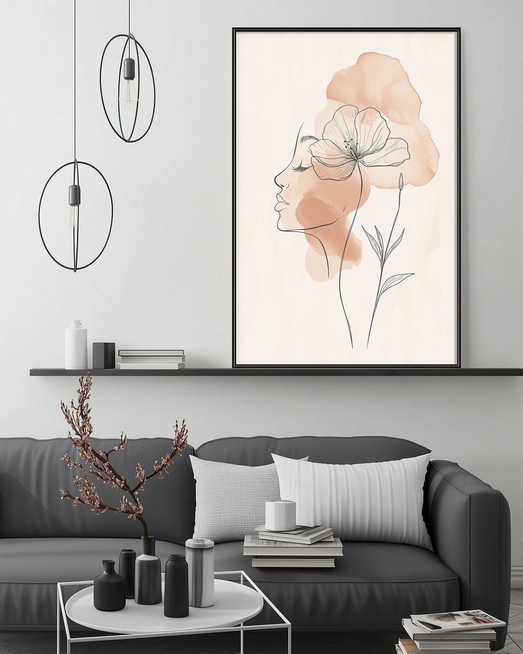 a modern living room with a gray sofa, a coffee table, and a large framed artwork depicting a woman's profile with a flower above it. The room has a minimalist and stylish design, with pendant lights hanging above the sofa and a shelf displaying decorative items.
