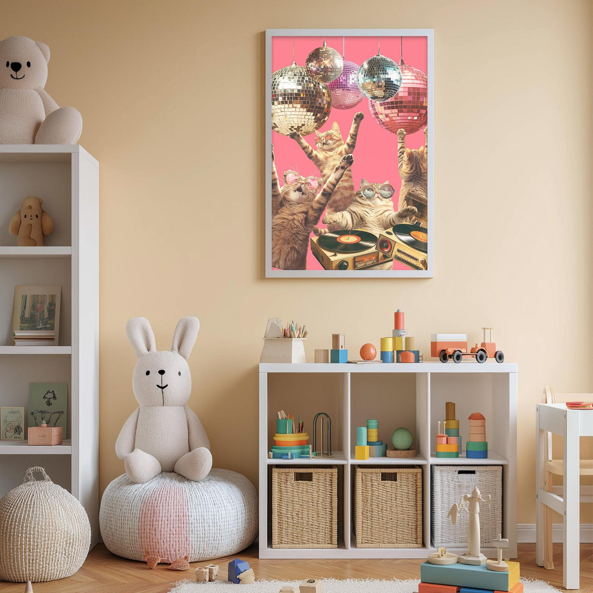 A child's bedroom with a white bookshelf, a stuffed rabbit, and a colorful toy box filled with various toys. Above the bookshelf is a framed poster featuring a group of cats and disco balls.
