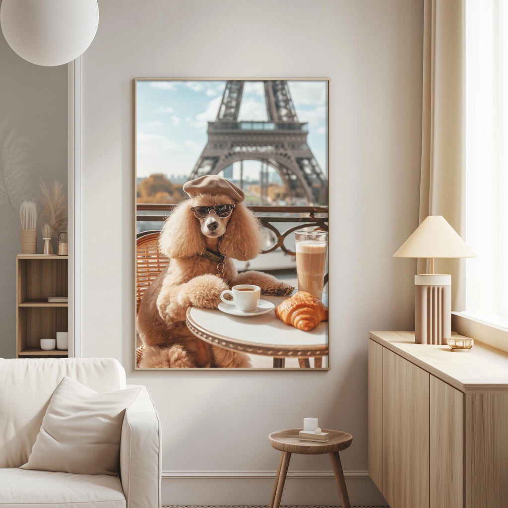 A large framed picture of a poodle dog sitting at a table with a cup of coffee and a croissant, with the Eiffel Tower visible in the background.