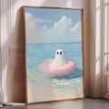 A framed painting depicting a ghost floating on a pink inner tube in the ocean, with a cloudy sky in the background.