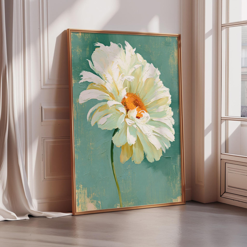 a large, vibrant painting of a white flower with an orange center, displayed on a wall in a room with a window.