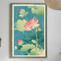 a dining table with a white tablecloth, a bowl of fruit, a bottle, and a vase with flowers. Above the table, there is a framed print of a lotus flower and green leaves on a blue background.