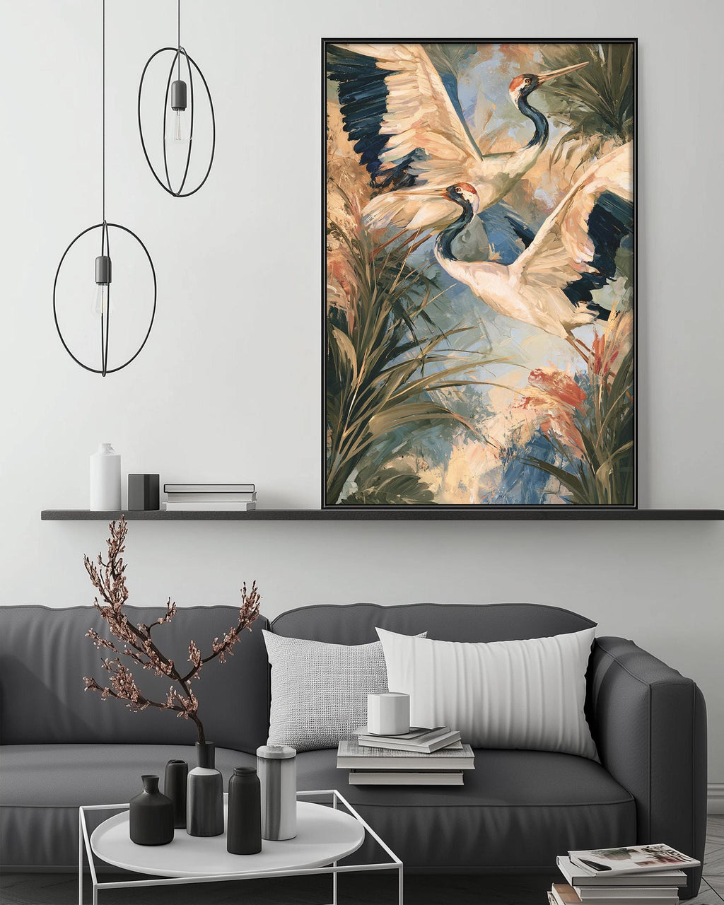 a large painting of two white birds with blue and green feathers, flying in a tropical forest setting, hanging on a wall above a gray couch with white pillows.