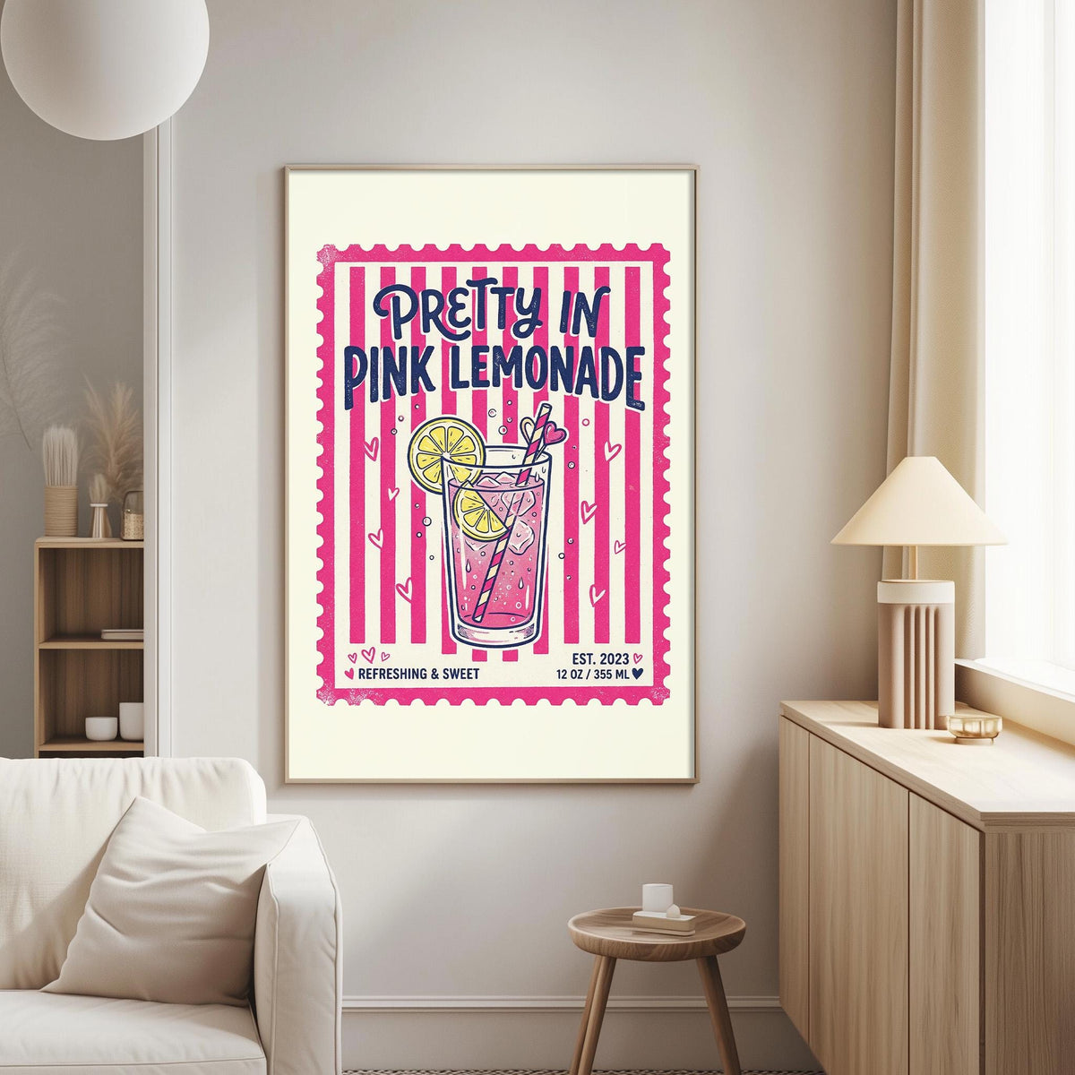a poster of a pink lemonade drink hanging on a wall in a living room.