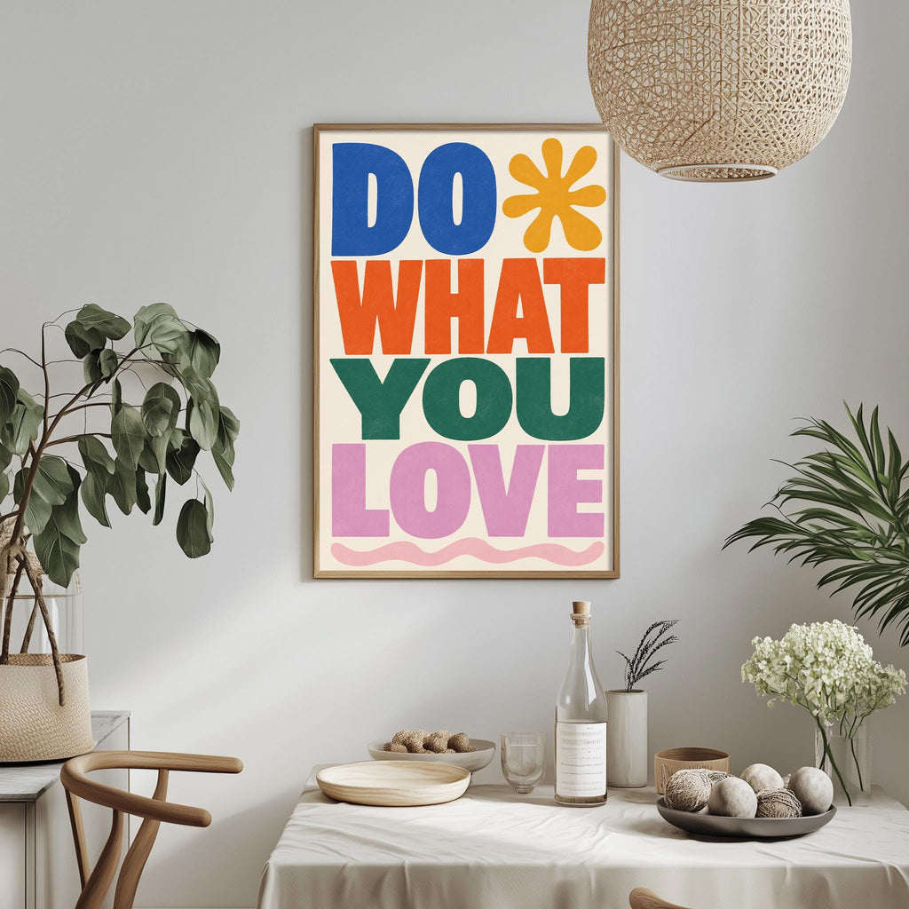 a colorful poster with the text "DO WHAT YOU LOVE" hanging on a wall above a dining table with various items on it, such as a bottle, a bowl, and a vase.