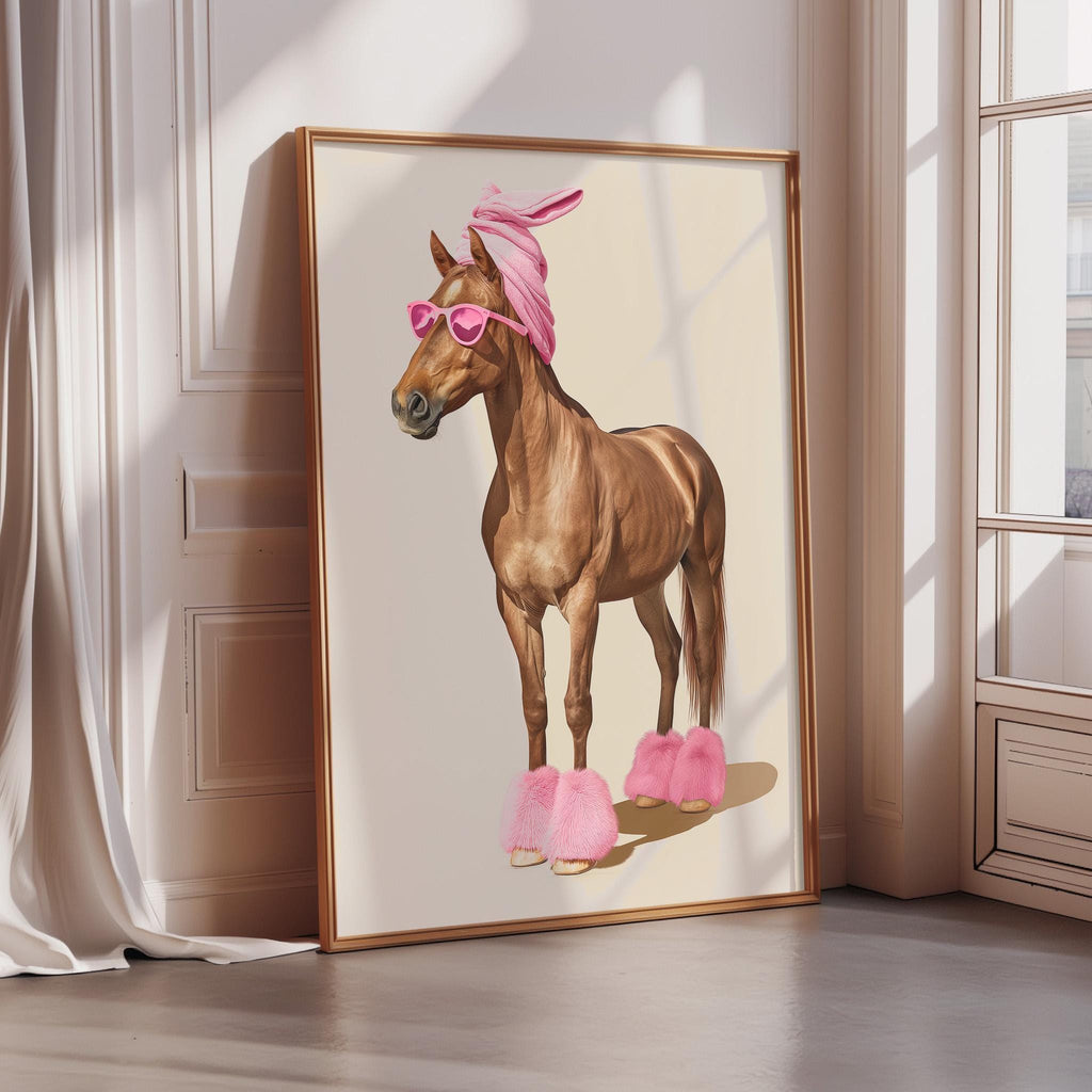 A framed illustration of a horse wearing pink sunglasses and pink pom poms on its feet, standing in a room with a white wall and a window.