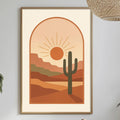 a desert-themed wall art with a cactus and a sun-like design, hanging above a dining table with a bottle, a bowl, and some plants.