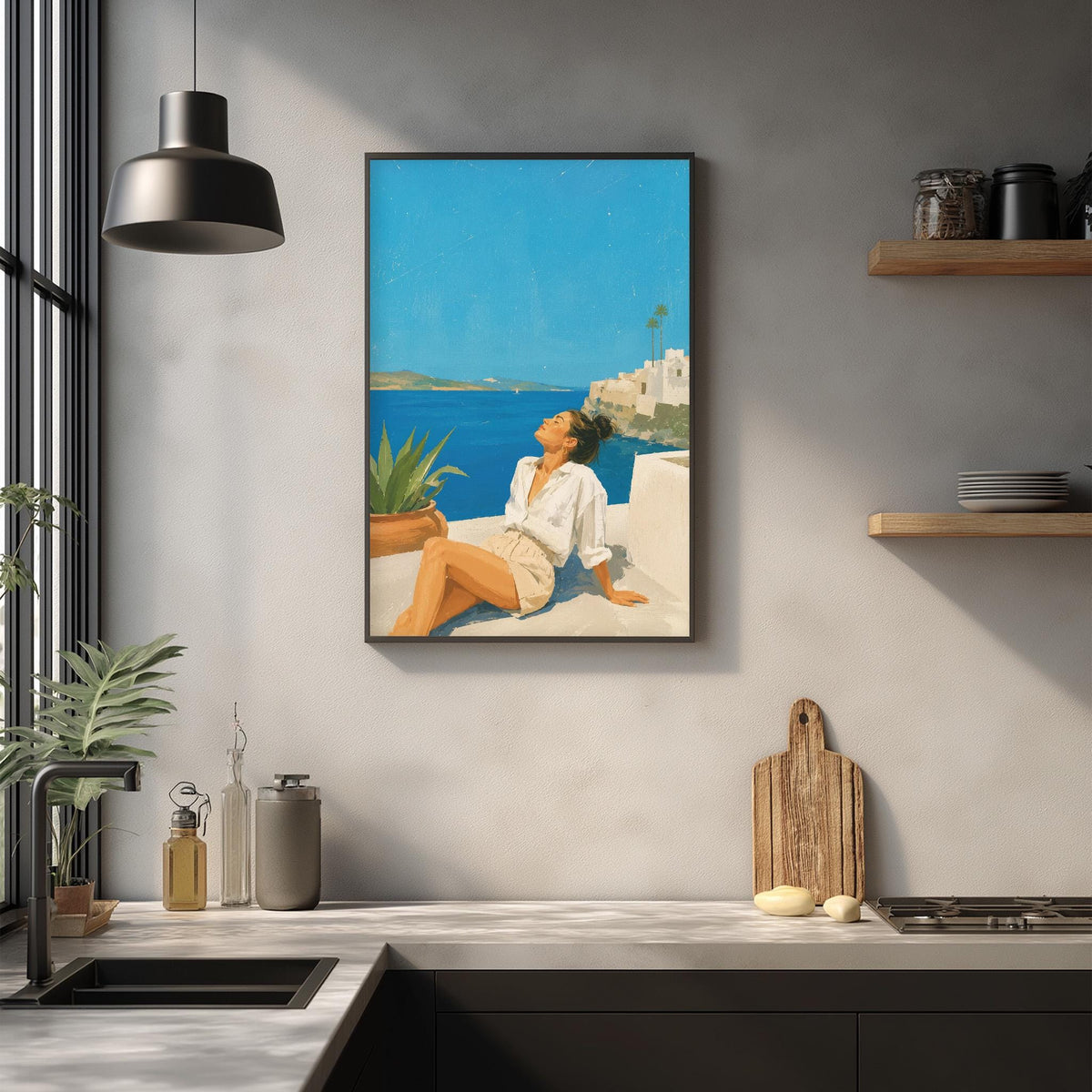 a woman sitting on a balcony overlooking the ocean, with a framed painting of the same scene hanging on the wall above the kitchen counter.