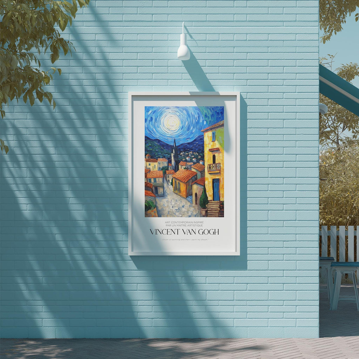 a framed painting of a colorful street scene, hanging on a blue brick wall.